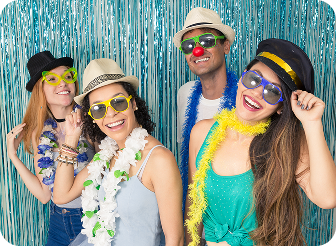 Four people posing in colorful party attire.