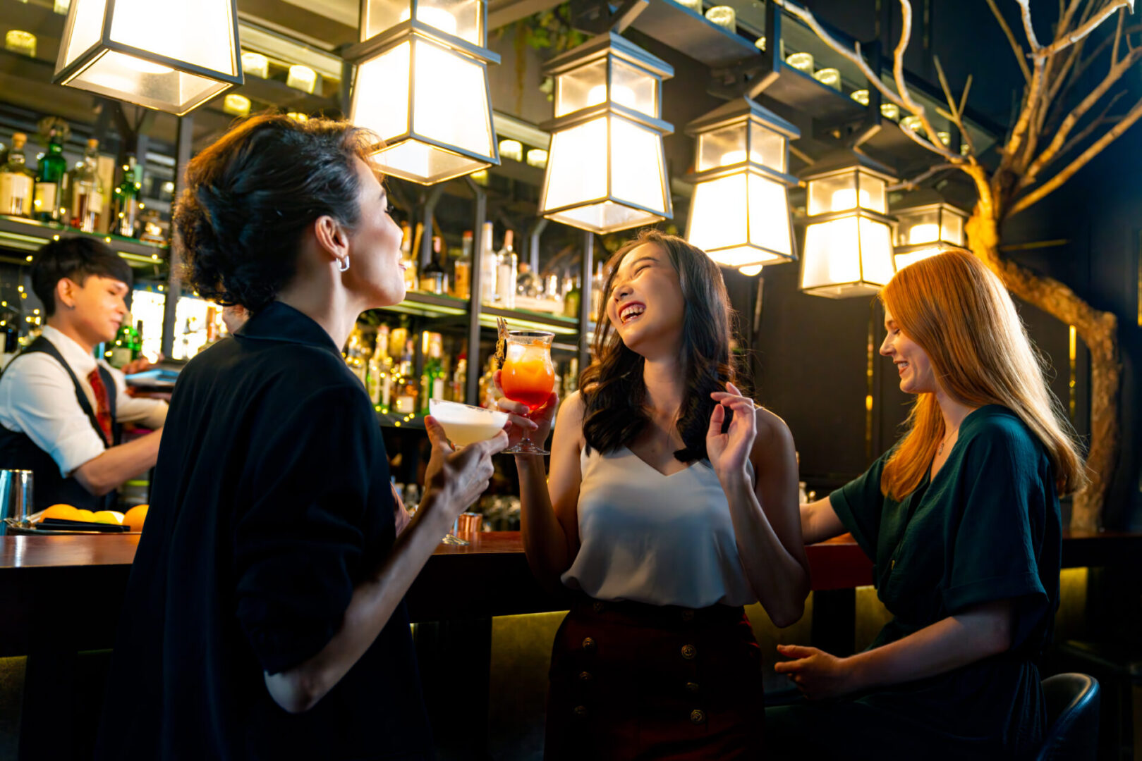 Group of Beautiful woman hangout nightlife party together at luxury bar. Women enjoying drinks at a bar.