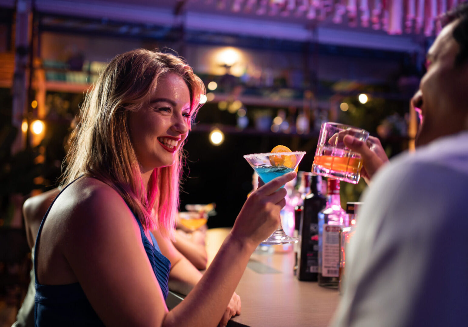 People enjoying drinks at a bar.